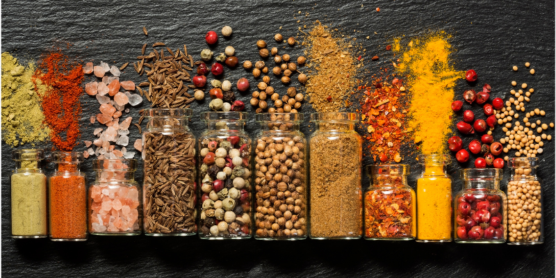 Assorted spices spilled out of glass jars