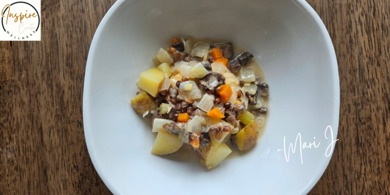 Creamy Potato Barley Soup in a white bowl on a table